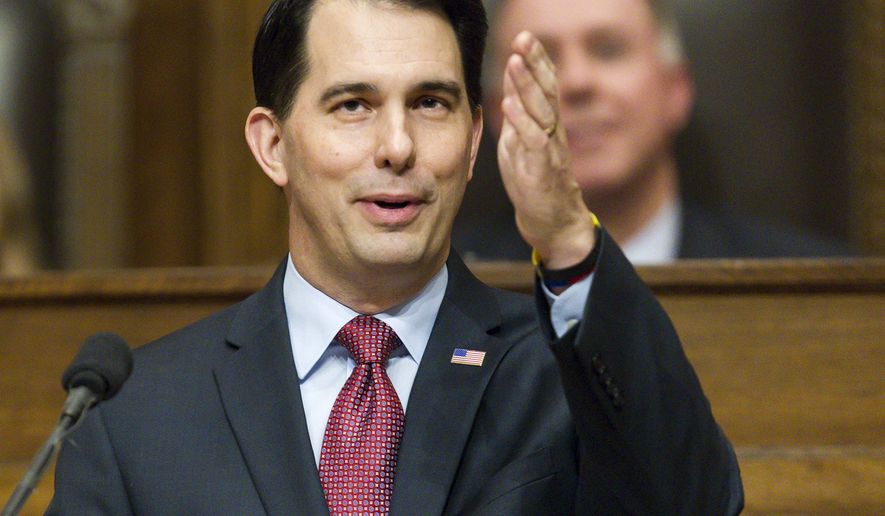 FILE - In this Jan. 13, 2015 file photo, Wisconsin Gov. Scott Walker acknowledges people in the gallery during Governor's State of the State address to a joint session of the Legislature in the Assembly chambers at the state Capitol in Madison, Wis. Walker has transformed Wisconsin politics, winning three elections in four years and signing laws that weaken unions, crippling a key component of the Democratic Party. But the likely Republican presidential contender has had less success changing Wisconsin’s economy and budget. The state lags in job growth and its budget faces a shortfall. It’s a record that complicates Walker’s path in early primary states as he sells himself as a reformer. (AP Photo/Andy Manis, File)
