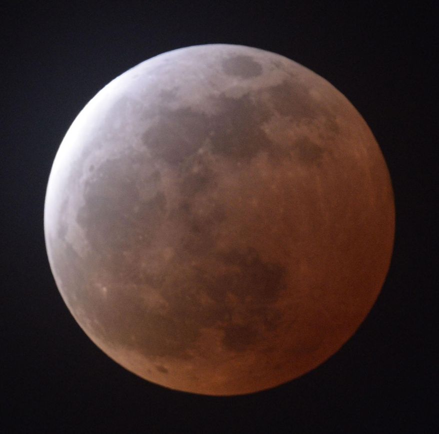 A total lunar eclipse is observed in Sendai, Miyagi prefecture, northeastern Japan, Saturday, April 4, 2015. (AP Photo/Kyodo News) JAPAN OUT, MANDATORY CREDIT