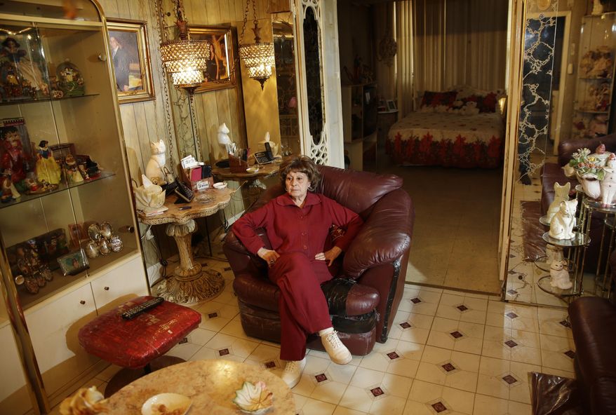 Adele Sarno poses for picture in her apartment in the Little Italy section of Manhattan, Tuesday, March 31, 2015, in New York. A fight in Manhattan’s Little Italy neighborhood between a landlord who wants a tenant out and a tenant who doesn’t want to go isn’t just the run-of-the-mill New York City real estate struggle. The landlord is a museum dedicated to the legacy of Italian Americans in the area. The tenant? Sarno, an 85-year-old Italian American woman, who’s lived there for more than 50 years. (AP Photo/Seth Wenig)