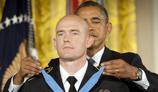 President Obama awards Staff Sgt. Ty Carter the Medal of Honor on April 26, 2013. (Associated Press) ** FILE **