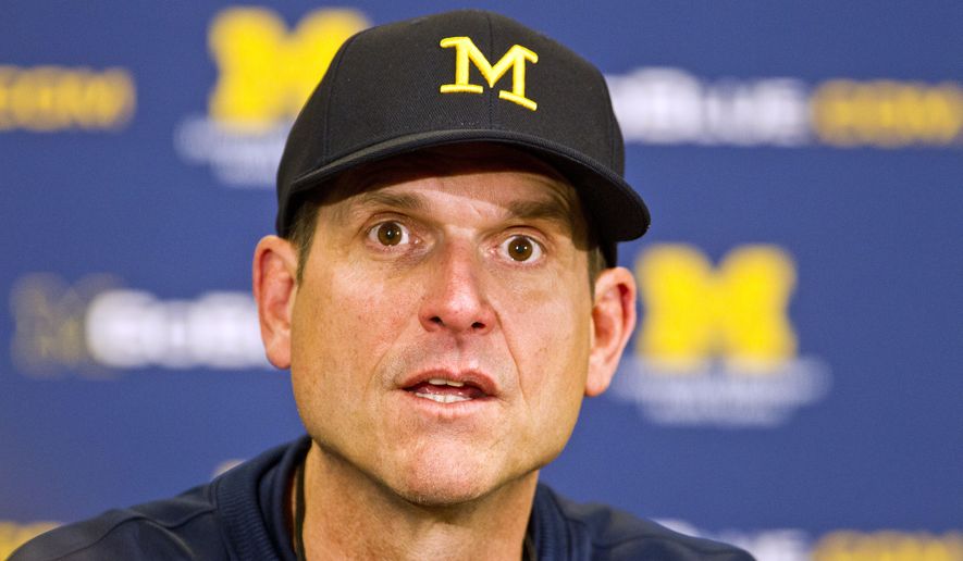 Michigan head coach Jim Harbaugh answers questions during a press conference after their spring NCAA college football game in Ann Arbor, Mich., Saturday, April 4, 2015. (AP Photo/Tony Ding)
