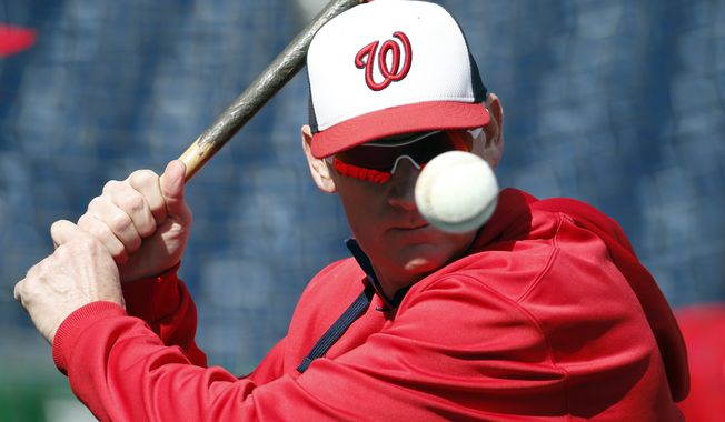 Washington Nationals manager Matt Williams prepares to hit a ball during batting practice before an exhibition baseball game against the New York Yankees at Nationals Park, Saturday, April 4, 2015, in Washington. (AP Photo/Alex Brandon)