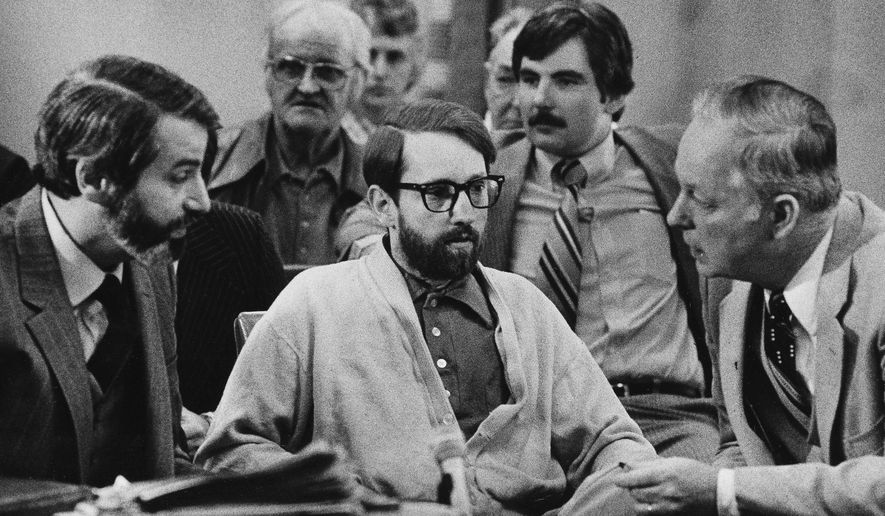 FILE-This March 18, 1980 file photo shows James Ruppert, center, listening to his attorneys, H.J. Bressler, left, and Hugh Holbrook, right, as they prepare to ask for a change of venue retrial in Butler County Common Pleas Court in Hamilton, Ohio. Ruppert had shot 11 members of his family, including his mother, Charity; his brother, Leonard Jr.; his sister-in-law, Alma; and their eight children, Leonard III, 17; Michael, 16; Thomas, 15; Carol, 13; Ann, 12; David, 11; Teresa, 9; and John, 4 in his mother???s home. Ruppert was convicted of two counts of murder and received a verdict of not guilty by reason of insanity for the other nine killings. He was sentenced to 11 life sentences and is currently in the Allen Correctional Institute in Lima. (AP Photo/Jeff Hinckley, File)