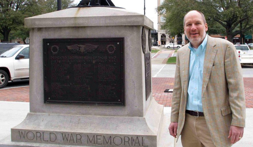 In this Jan. 22, 2015 photo, Greenwood Mayor Welborn Adams stands beside the Greenwood County memorial in Greenwood, S.C., that honors its citizens who died in recent wars. The mayor's push to put new plaques on his city's war memorial to remove old ones that split soldiers killed in World War I and II into "white' and "colored" appears to have died in the Legislature. State Senate leaders plan to ignore the bill the rest of this session, saying it would open old wounds created when the state debated removing the Confederate flag from atop the Statehouse dome 15 years ago. (AP Photo/Jeffrey Collins)