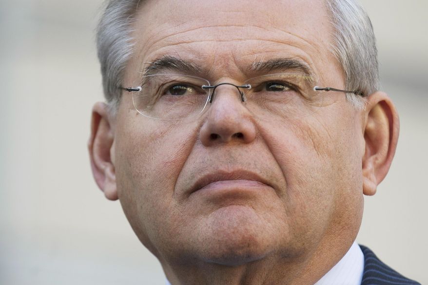 U.S. Sen. Bob Menendez waits to speak outside federal court, Thursday, April 2, 2015, in Newark, N.J. Menendez, the top Democrat on the U.S. Senate Foreign Relations Committee, was indicted on corruption charges, accused of using his office to improperly benefit an eye doctor and political donor. (AP Photo/John Minchillo)