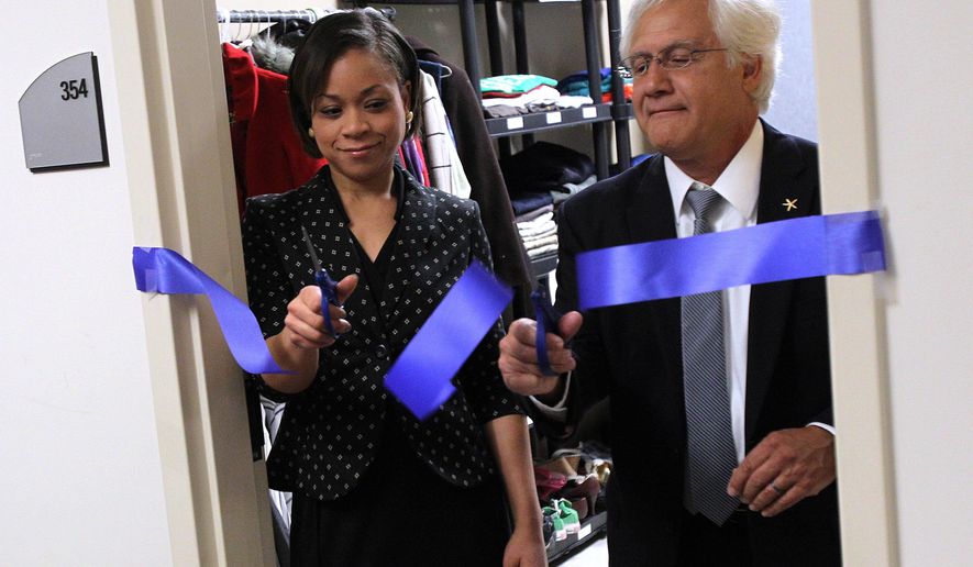 ADVANCE FOR SUNDAY APRIL 5 AND THEREAFTER - In this Wednesday March 25, 2015 photo, ountwest Community & Technical College President Keith Cotroneo, right, and mental health counselor Candace Layne cut the ribbon for a new on-campus food pantry and clothing closet for students at MCTC on in Huntington, W.Va. (AP Photo/The Herald-Dispatch, Lori Wolfe)