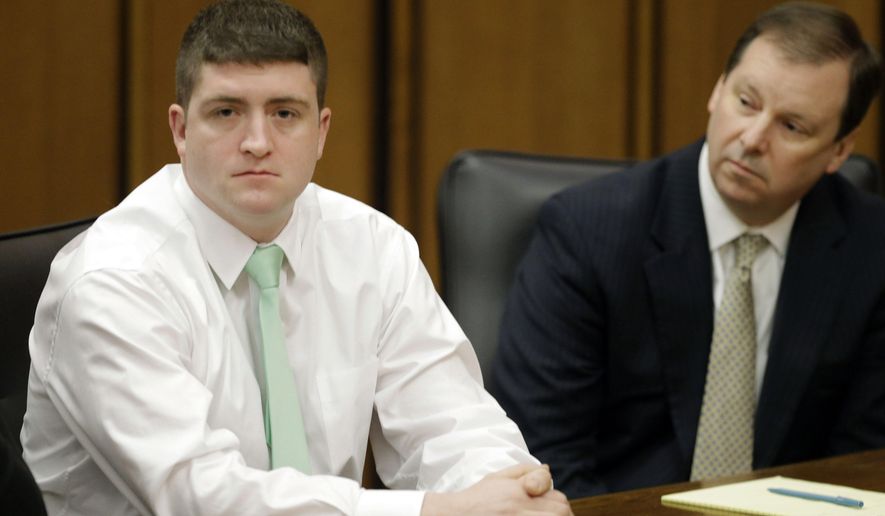 FILE - In this March 13, 2015 file photo, suspended Cleveland Police patrolman Michael Brelo, left, sits with attorney Tom Shaughnessy during an administrative hearing in Cleveland. Brelo faces two voluntary manslaughter charges in the shooting deaths of Timothy Russell and Malissa Williams following a high-speed chase in November 2012. His trial is scheduled to begin Monday, April 6, 2015 in Cleveland. (AP Photo/Mark Duncan, File)