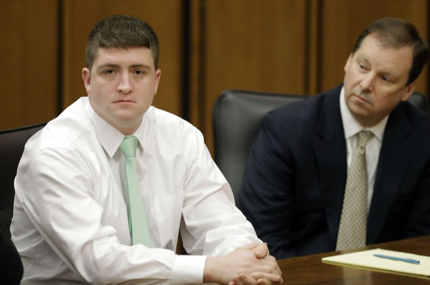 FILE - In this March 13, 2015 file photo, suspended Cleveland Police patrolman Michael Brelo, left, sits with attorney Tom Shaughnessy during an administrative hearing in Cleveland. Brelo faces two voluntary manslaughter charges in the shooting deaths of Timothy Russell and Malissa Williams following a high-speed chase in November 2012. His trial is scheduled to begin Monday, April 6, 2015 in Cleveland. (AP Photo/Mark Duncan, File)