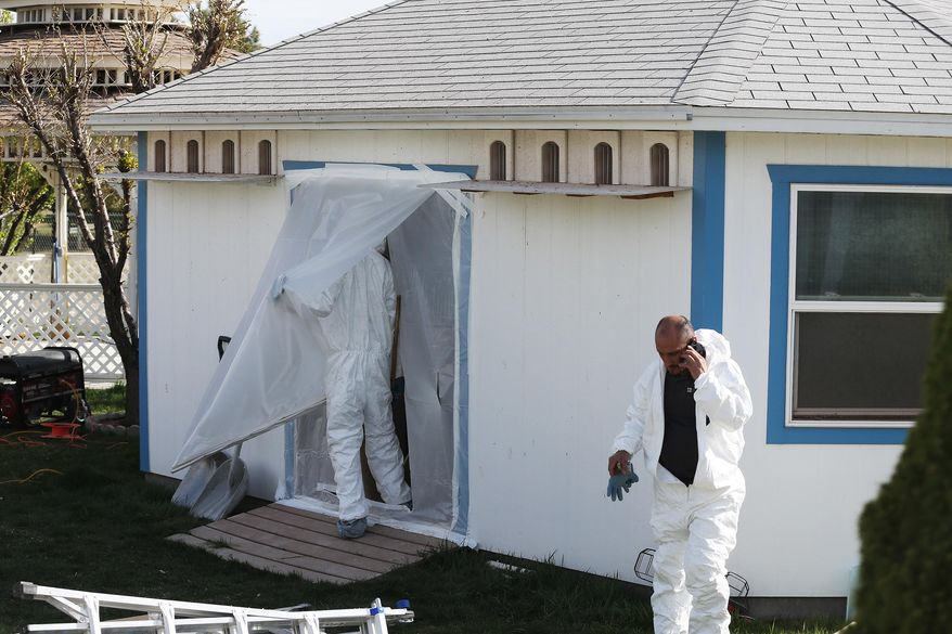 FILE - In this Tuesday, March 31, 2015 file photo, workers clean out and begin to tear down a pigeon loft in 75-year-old Boris Majnaric's backyard in South Jordan, Utah. Majnaric is distraught after city officials tore down his backyard house built to house 200 pigeons _ five times as many as allowed under city rules. (AP Photo/The Deseret News, Jeffrey D. Allred, File) SALT LAKE TRIBUNE OUT; MAGS OUT