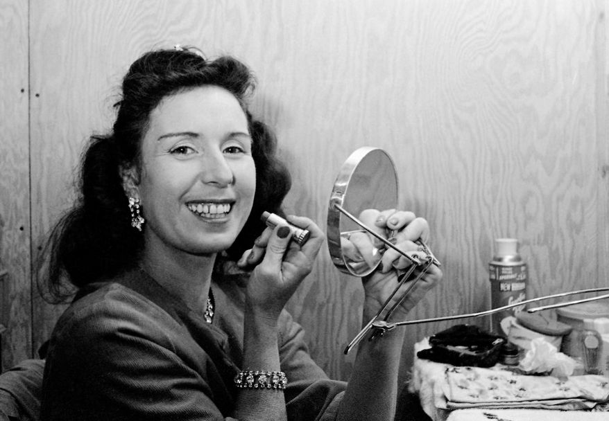 FILE - In this Jan. 24, 1964 file photo, Jenny Wallenda, a member of the famous Wallenda high wire act, applies makeup in a dressing room prior to appearing at opening of the Shrine Circus in Detroit. Wallenda, the matriarch of the famous family of high-flying circus performers, died late Saturday, April 4, 2015, at her home in Sarasota, Fla., according to family members. She was 87. (AP Photo/Alvan Quinn, File)