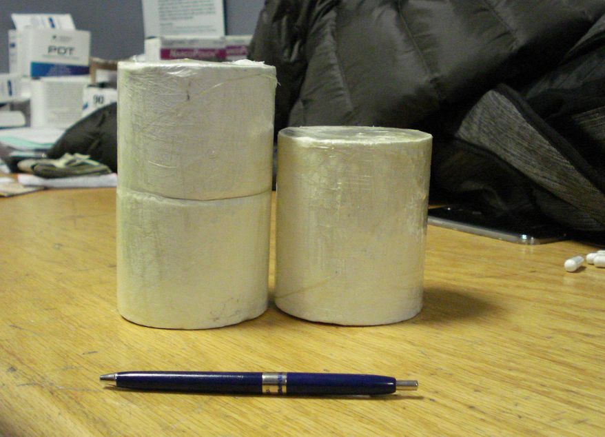 This April 1, 2015 photo provided by U.S. Customs and Border Protection shows cylinders of heroin weighing approximately two pounds in the U.S. Customs and Border Protection office at John F. Kennedy International Airport in New York. CPB agents say they intercepted the heroin as Colombian citizen, Ivan Vidal Forero, tried to smuggle it into the country hidden in his underwear. (AP Photo/U.S. Customs and Border Protection)