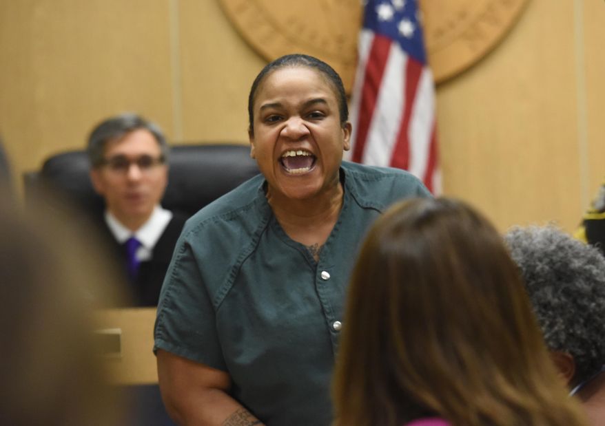 Mitchelle Blair yells out at Alex Dorsey, father of one of the children found dead in a freezer in Blair's home, at Lincoln Hall of Justice in Detroit, Wednesday, April 8, 2015. Blair, charged with slaying two of her children, was removed from court after yelling at Dorsey during a parental rights termination hearing. (AP Photo/Detroit News, Daniel Mears)