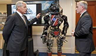 Before leaving office, Defense Secretary Chuck Hagel got a look at high-tech projects being developed by the Defense Advanced Research Projects Agency. Brad Tousley demonstrated a robot that would assist wounded warriors. (Associated Press)