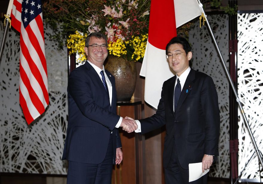U.S. Defense Secretary Ash Carter, left, shakes hands with Japanese Foreign Minister Fumio Kishida before their working lunch at the foreign ministry&#x27;s Iikura guest house in Tokyo Wednesday, April 8, 2015. (AP Photo/Yuya Shino, Pool)