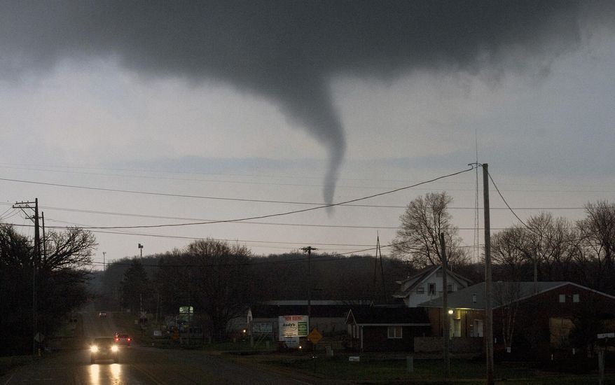 A funnel cloud crosses south Perryville Road on Thursday, April 9, 2015, south of Interstate 39 in Rockford, Ill. (AP Photo/Rockford Register Star, Max Gersh) MANDATORY CREDIT