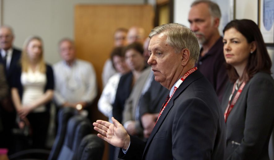 Sen., Lindsey Graham, R-S.C., talks to employees after touring New Hampshire Ball Bearings Thursday April 9, 2015 in Laconia, N.H. Lindsey met with workers to discuss their support of legislation re-authorizing the Export-Import Bank.  (AP Photo/Jim Cole)