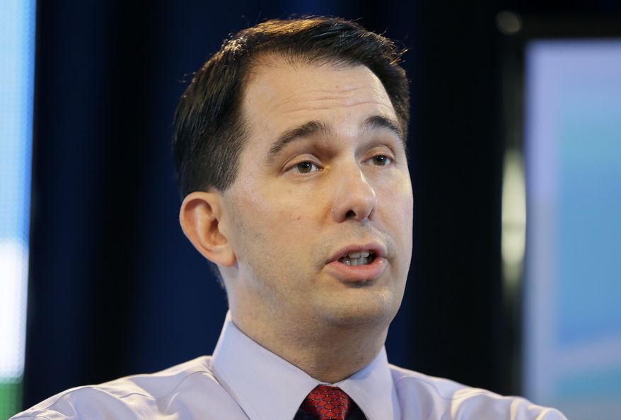 FILE - In this March 7, 2015, file photo, Wisconsin Gov. Scott Walker speaks during the Iowa Agriculture Summit in Des Moines, Iowa. Gov. Walker heads to Europe this week on a trade mission featuring private meetings with business and government representatives in Germany, France and Spain, as he ramps up for a likely bid for the Republican presidential nomination in 2016. (AP Photo/Charlie Neibergall, File)