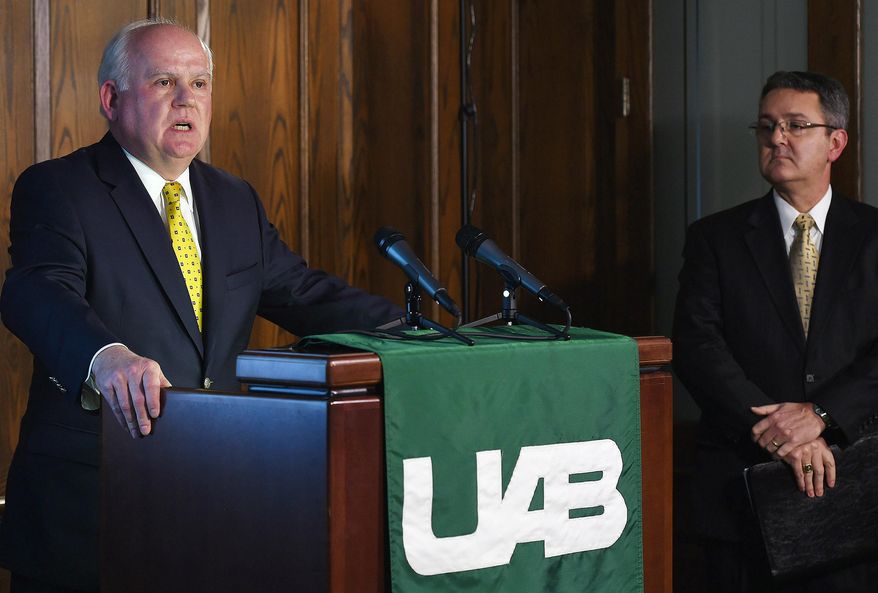 FILE - In this Dec. 2, 2014, file photo, University of Alabama at Birmingham President Ray Watts, left, and UAB Vice President for Financial Affairs and Administration Allen Bolton, right, address the media during a news conference to discuss the results of their athletics strategic planning process and closing of the UAB football football, rifle, and bowling programs in Birmingham. Ala. Former UAB players are making sure the Blazers get at least one more game at Legion Field. They'll gather Saturday, April 11, 2015, for the Sons of UAB alumni flag football game.(AP Photo/Tamika Moore, AL.com, File) MAGS OUT