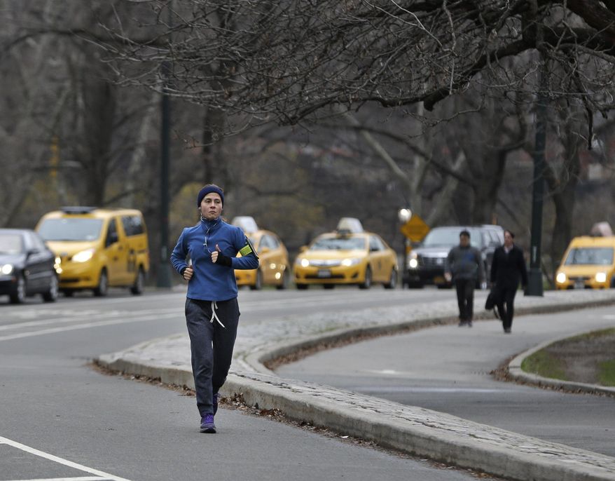 A person takes a morning run through Central Park in New York, Thursday, April 9, 2015. Many business travelers like to go out for morning jogs in whatever city they’re traveling to. Often they pick a well-known route so they can sightsee a bit, stay safe and so they won’t get lost. (AP Photo/Seth Wenig)