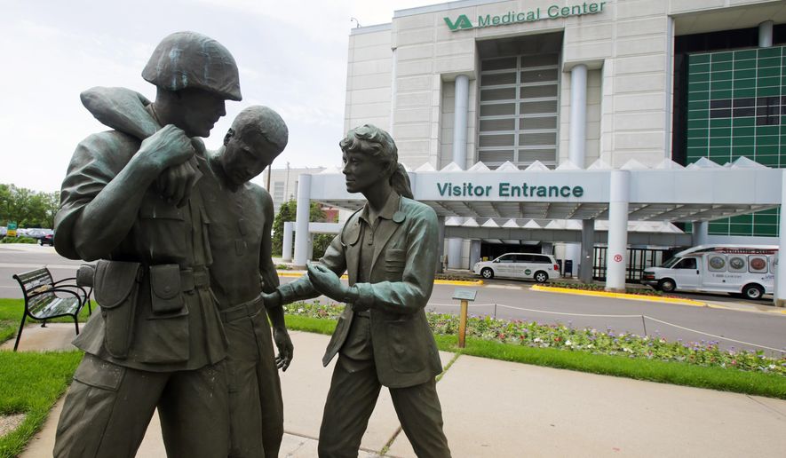 A sculpture portraying a wounded soldier being helped on the grounds of the Minneapolis VA Hospital. Minnesota’s Veterans Affairs clinics and hospitals fare slightly better in delivering timely care to veterans than the national average between September and February, according to six months of appointment data analyzed by the Associated Press. (AP Photo/Jim Mone, File)