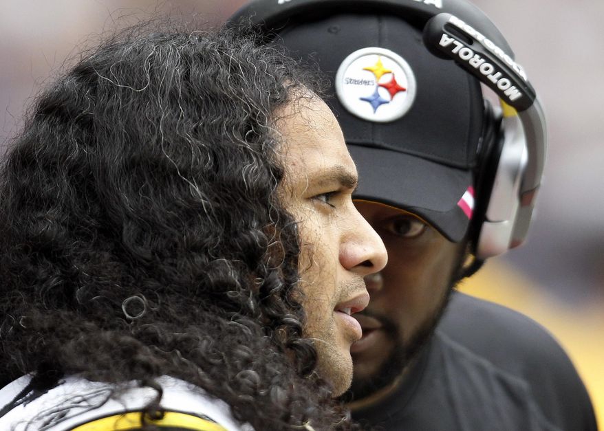 FILE - In this Oct. 2, 2011, file photo, Pittsburgh Steelers coach Mike Tomlin, right, talks to strong safety Troy Polamalu during an NFL football game against the Houston Texans in Houston. Polamalu's iconic football career is over. The eight-time Pro Bowl safety told the Uniontown Herald-Standard he informed Steelers chairman Dan Rooney on Thursday night, April 9, 2015, he will retire rather than return for a 13th season. (AP Photo/Eric Gay, File)