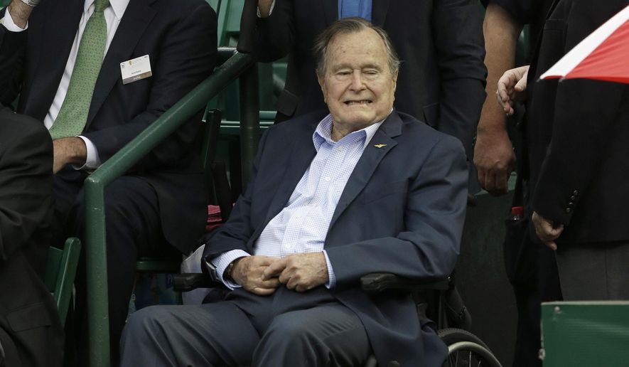 Former President George H.W. Bush, seated, arrives at the River Oaks Country Club just before the quarterfinal match between Jeremy Chardy of France and Kevin Anderson from South Africa was suspended by rain at the U.S. Men&#39;s Clay Court Championship Friday, April 10, 2015, in Houston. (AP Photo/Pat Sullivan)