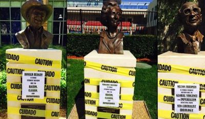 Chapman University says the protest signs that were plastered overnight Wednesday on the busts for conservative icons like Ronald Reagan and Margaret Thatcher can stay, citing the students&#39; right to free speech. (Reddit/TheRealLouisWu)