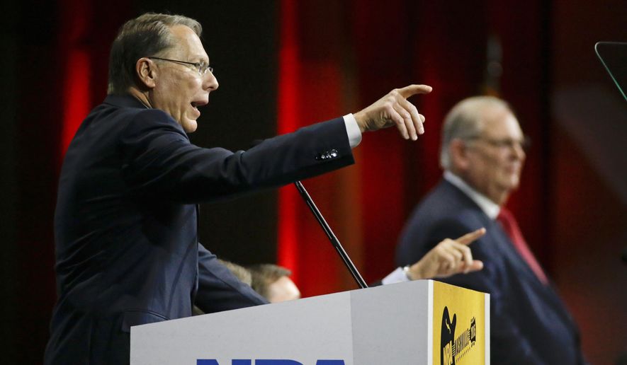 Wayne LaPierre, left, executive vice president of the National Rifle Association, speaks during the annual meeting of members at the NRA convention Saturday, April 11, 2015, in Nashville, Tenn. At right is Jim Porter, NRA president. (AP Photo/Mark Humphrey)