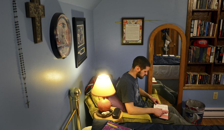 MEMBER FEATURE EXCHANGE FOR APRIL 11 -- In this April 2, 2015 photo, Michael Bovino reads his evening prayers in his room as he enjoys some time with his family at their Stonington, Conn., home while on Easter break from Mount St. Mary's Seminary in Maryland. (AP Photo/The Day, Tim Cook) MANDATORY CREDIT **FILE**