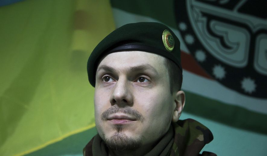 In this photo taken on Monday March 2, 2015, Adam Osmayev, the commander of a battalion of Chechens fighting against Russia-backed rebels, is in the town of Lysychansk, Ukraine. Russian pro-Kremlin newspapers published reports based on unidentified sources in the security services that accused the Ukrainian government and Osmayev of ordering the murder of Russian opposition leader Boris Nemtsov, the claims Osmayev has denied. (AP Photo/Olya Engalycheva)