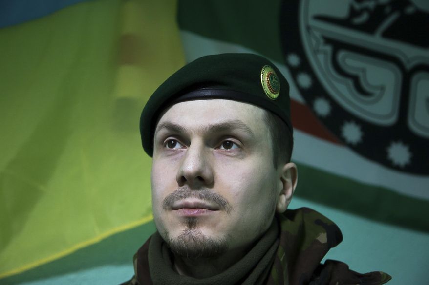 In this photo taken on Monday March 2, 2015, Adam Osmayev, the commander of a battalion of Chechens fighting against Russia-backed rebels, is in the town of Lysychansk, Ukraine. Russian pro-Kremlin newspapers published reports based on unidentified sources in the security services that accused the Ukrainian government and Osmayev of ordering the murder of Russian opposition leader Boris Nemtsov, the claims Osmayev has denied. (AP Photo/Olya Engalycheva)