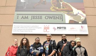 Students from The Duke Ellington School of the Arts pose with the Jesse Owens Mural at The Reeves Center in the District (Focus Features photographs)