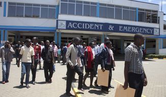 University students leave after treatment at Kenyatta National Hospital, Sunday, April 12, 2015, in Nairobi, Kenya. One Kenyan student was killed and 141 injured in a stampede Sunday on the campus of the University of Nairobi when students mistook several accidental explosions for another extremist attack, according to an official. (AP Photo/Sayyid Azim)