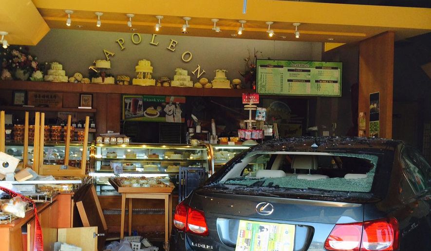 This photo provided by the Fairfax County Police Department shows a car that crashed into the Napoleon Bakery in Annandale, Va. on Sunday, April 12, 2015. Fairfax County police say six people were injured. (Fairfax County Police Department via AP)