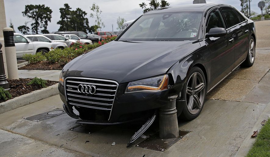 The car of La. Rep. Paul Hollis, R-Covington, is seen after a security ballast rose underneath it, Monday, April 13, 2015, at the Capitol in Baton Rouge, La. Hollis says he was inching his vehicle through the parking lot exit when a new security system engaged. Hollis suffered minor injuries on the opening day of the Louisiana State Legislature. (AP Photo/Gerald Herbert)