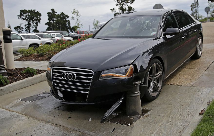 The car of La. Rep. Paul Hollis, R-Covington, is seen after a security ballast rose underneath it, Monday, April 13, 2015, at the Capitol in Baton Rouge, La. Hollis says he was inching his vehicle through the parking lot exit when a new security system engaged. Hollis suffered minor injuries on the opening day of the Louisiana State Legislature. (AP Photo/Gerald Herbert)
