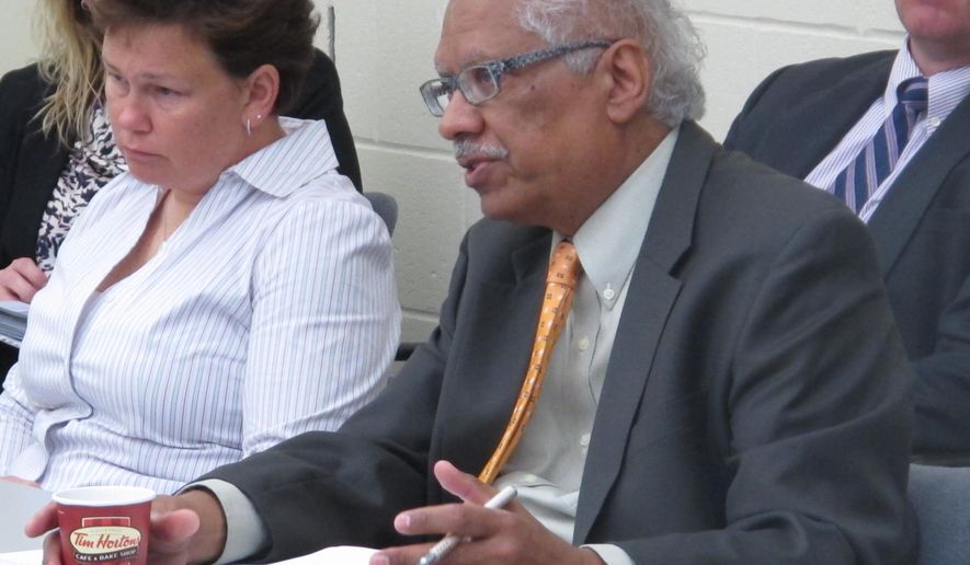Reggie Wilkinson, right, chairman of the Ohio Attorney General's Advisory Group on Law Enforcement Training, moderates debate over whether the state has too many police training academies as Columbus police commander Rhonda Grizzell observes, on Monday, April 13, 2015, in Columbus, Ohio. Wilkinson said a final decision on whether to recommend closing some academies hasn't been made. (AP Photo/Andrew Welsh-Huggins)