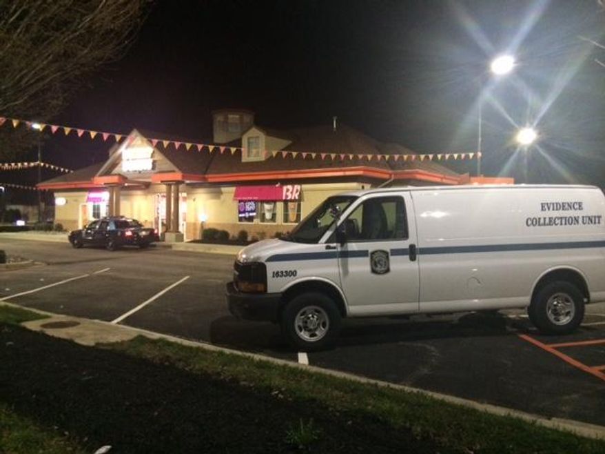Police respond to the scene of a homicide Sunday, April 12, 2015, in a Dunkin' Donuts in Hanover, Md., in an undated image provided by the Anne Arundel County, Md., Police. Police are searching for a man charged with killing his wife at the Dunkin' Donuts where they worked. Anne Arundel County police said in a press release Monday that an officer checked the business and found a severely injured woman in the kitchen area. Police say the woman, 21-year-old Palak Bhadreskumar Patel of Hanover, died at the scene. Police say the investigation revealed that Patel's husband, 24-year-old Bhadreshkumar Chetanbhai Patel, hit her multiple times with an object and then fled. They say Patel has been charged with murder, assault and a weapons offense.