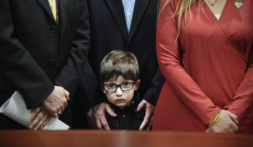 Hayden Lewis, of Norwalk, Conn., cousin of Sandy Hook School shooting victim Jesse Lewis, stands with family during a news conference at the Legislative Office Building, Monday, April 13, 2015, in Hartford, Conn. Connecticut's congressional delegation is backing federal legislation that would honor Lewis and provide expanded support to train teachers in social and emotional learning. (AP Photo/Jessica Hill)