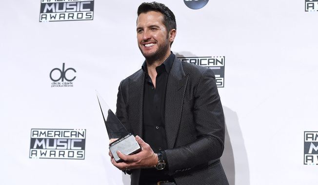 Luke Bryan, winner of the award for favorite country male artist, poses in the press room at the 42nd annual American Music Awards at Nokia Theatre L.A. Live on Sunday, Nov. 23, 2014, in Los Angeles. (AP)