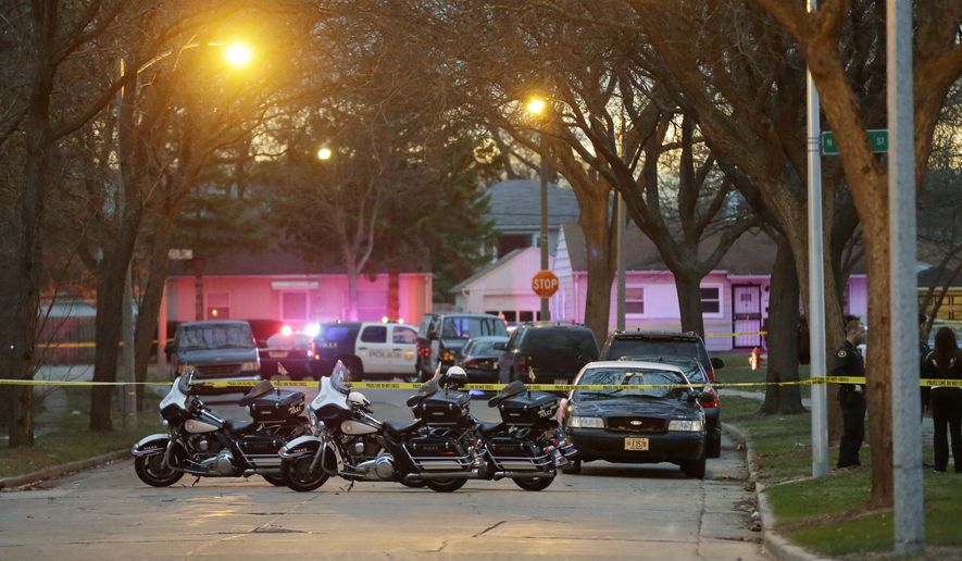 In this April 12, 2015 photo, police investigate the scene of a indecent that left a toddler and two others dead in Milwaukee. Archie Brown Sr. says his son, Archie Brown Jr., was shot to death after his van struck and killed a toddler on Sunday. Brown also says a neighbor riding with his son told him the teenager came out of a house near the scene and was trying to help when both were shot. (Mike De Sisti/Milwaukee Journal Sentinel via AP)