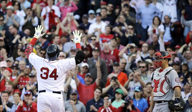 Boston Red Sox designated hitter David Ortiz (34) gestures at the plate after his home run in the sixth inning as Washington Nationals catcher Jose Lobaton watches in the home opener baseball game at Fenway Park in Boston, Monday, April 13, 2015. The Red Sox won 9-4. (AP Photo/Elise Amendola)