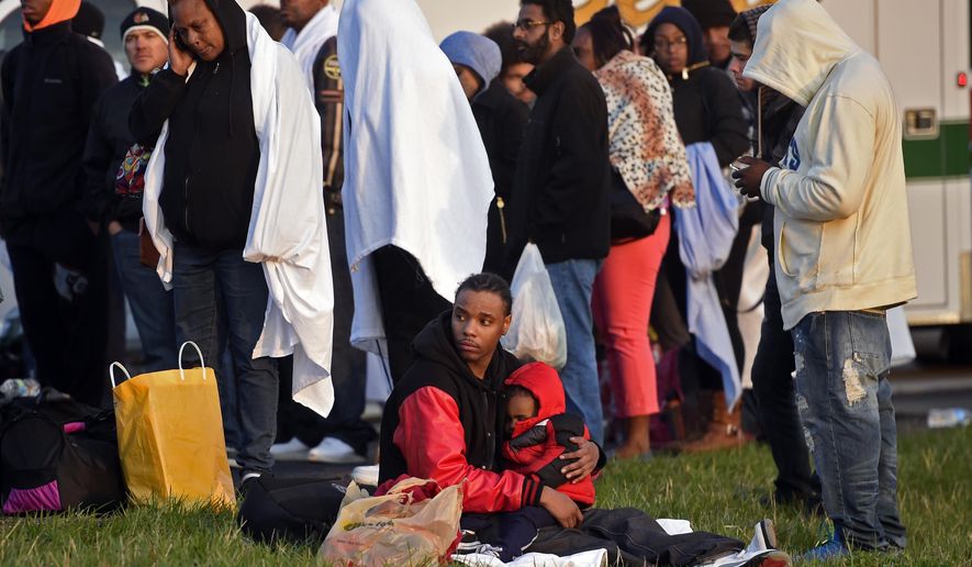 Megabus passengers wait along southbound Interstate 65 for buses to arrive at the crash scene to take them to Indianapolis after a Megabus was involved in a four-vehicle crash, Monday, April 13, 2015, in Edinburgh, Ind. Nineteen passengers suffered non-life-threatening injuries when a Megabus heading from Chicago to Atlanta struck the back of a stopped semitrailer on I-65, Indiana State Police said. (Scott Roberson/The Daily Journal via AP)