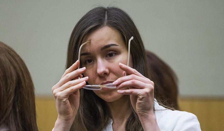 Jodi Arias puts on her glasses during her sentencing retrial at Maricopa County Superior Court in Phoenix in this Feb. 18, 2015, file photo. (Tom Tingle/Pool Photo via AP, File)