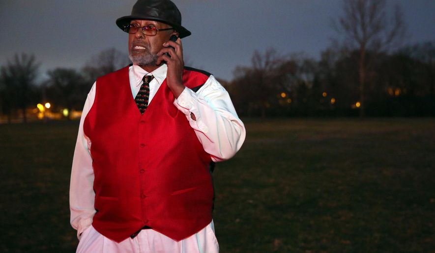 Archie Brown Sr., father of fatal shooting victim Archie Brown Jr., talks on his mobile phone in Wahl Park, just to the east of the incident where his son was killed, Sunday, April 12, 2015. Archie Brown Sr. says his son, Archie Brown Jr., had got out of his van Sunday after striking the 2-year-old and picked up the boy. Brown says a neighbor riding with his son told him the teenager came out of a house near the scene and was trying to help when both were shot. (Mike De Sisti/Milwaukee Journal-Sentinel via AP)