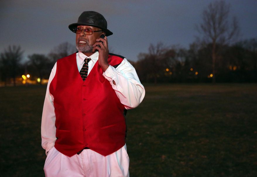 Archie Brown Sr., father of fatal shooting victim Archie Brown Jr., talks on his mobile phone in Wahl Park, just to the east of the incident where his son was killed, Sunday, April 12, 2015. Archie Brown Sr. says his son, Archie Brown Jr., had got out of his van Sunday after striking the 2-year-old and picked up the boy. Brown says a neighbor riding with his son told him the teenager came out of a house near the scene and was trying to help when both were shot. (Mike De Sisti/Milwaukee Journal-Sentinel via AP)