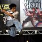 FILE - In this July 7, 2007 file photo, Freddie Wong, 21, of Seattle, Wash.,  plays Guitar Hero II on stage at the World Series of Video Games, in Grapevine, Texas. After a five year absence, &amp;quot;Guitar Hero&amp;quot; and &amp;quot;Rock Band&amp;quot; are planning a reunion tour in 2015 on the current generation of video game consoles. While the new rendition of “Guitar Hero” is offering a revamped controller, “Rock Band” is promising backward compatibility.  (AP Photo/D.J. Peters, File)