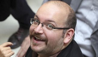 Jason Rezaian, an Iranian-American correspondent for the Washington Post, smiles as he attends a presidential campaign of President Hassan Rouhani in Tehran, Iran, April 11, 2013. (Associated Press) ** FILE **