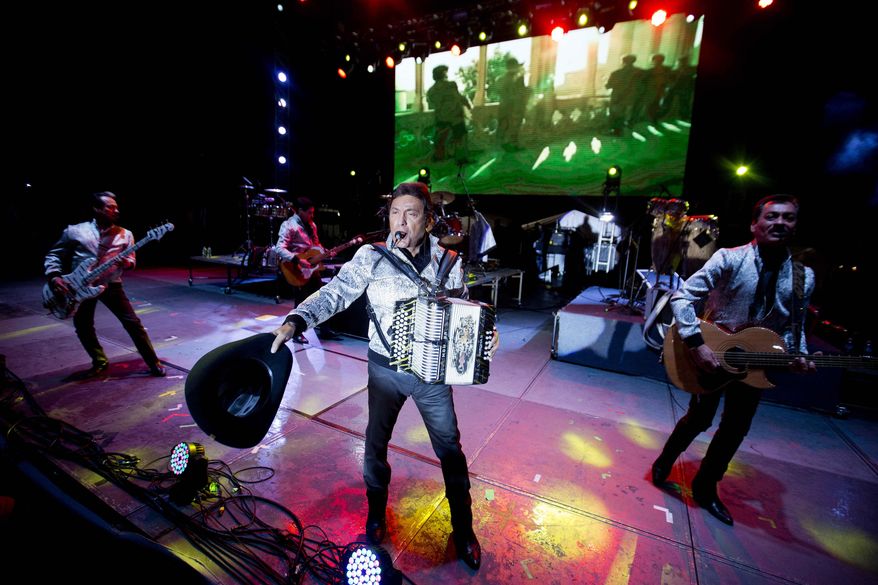FILE - In this Sept. 27, 2014 file photo, Los Tigres del Norte perform at the Somos America music festival in Toluca, Mexico. With “Era diferente,” the first corrido about gay love, Los Tigres del Norte say they are proud to support the LGBT community. The song is included in their latest album, “Realidades.” (AP Photo/Eduardo Verdugo, File)