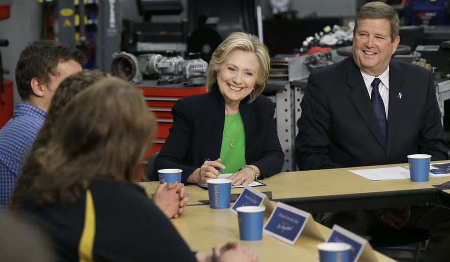 Democratic presidential candidate Hillary Rodham Clinton, accompanied by Kirkwood Community College President Mick Starcevich, right, participates in a roundtable with educators and students at the Kirkwood Community College&#x27;s Jones County Regional Center, Tuesday, April 14, 2015, in Monticello, Iowa. (AP Photo/Charlie Neibergall)